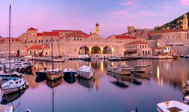 Sunset view of the Old Port of Dubrovnik, Croatia, and its many boats