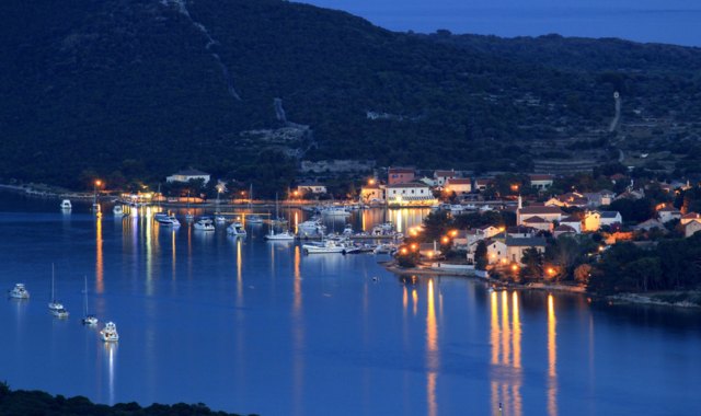 Ilovik’s small harbor lit up at night, Croatia