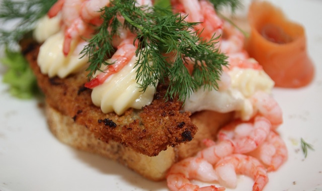 A Danish open-faced sandwich with fish, meat and vegetables