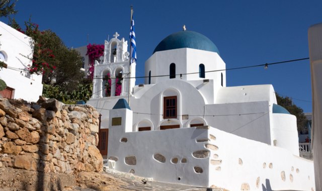 White church with blue dome in Donousa, typical of Cycladic architecture