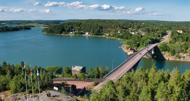 Road bridge connecting islands with lush vegetation in Åland