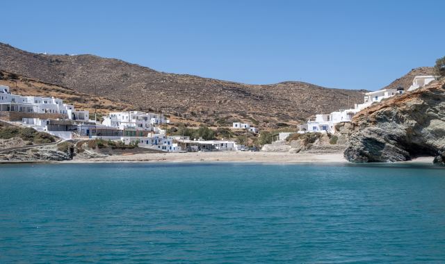 Boats off the coast of Folegandros sailing on clear blue waters