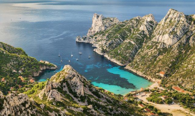 Aerial view of Calanque de Sormiou beach with sailboats, France