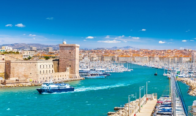 Aerial panoramic view of Marseille Old Port with the city and mountains in the background, France