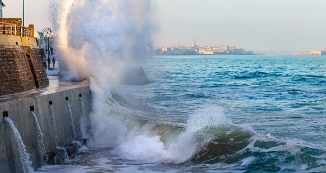 Big wave smashing against sea wall during high tide in Saint-Malo