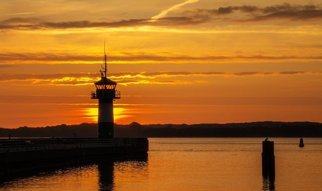 Sunset view of the lighthouse at the port of Travemünde