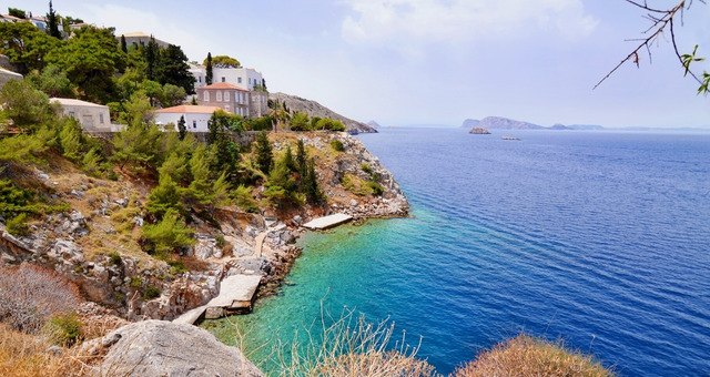 Avlaki beach in Hydra with rocks and emerald waters