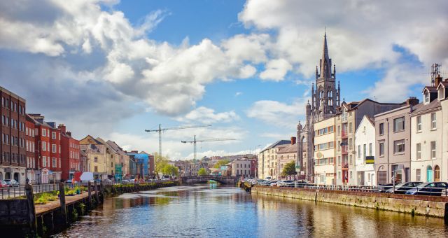 The Holy Trinity Church standing behind colorful houses in Cork