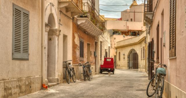 Bicycles parked in a narrow alley in Favignana's historic center