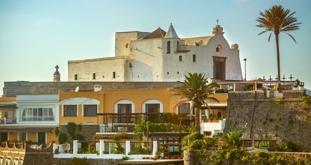 The small white church of Soccorso at the peak of the sea in Forio, Ischia, Italy