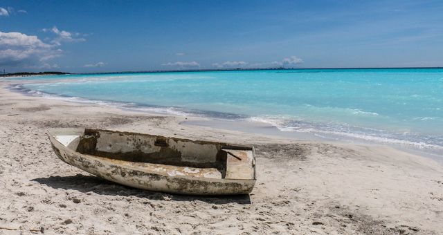 Small boat wreck on the white beach of Vada in Livorno, Italy