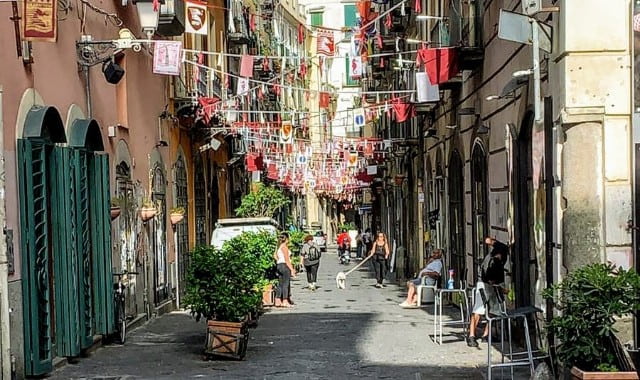 People seen at an alley in the historic center of Salerno, Italy