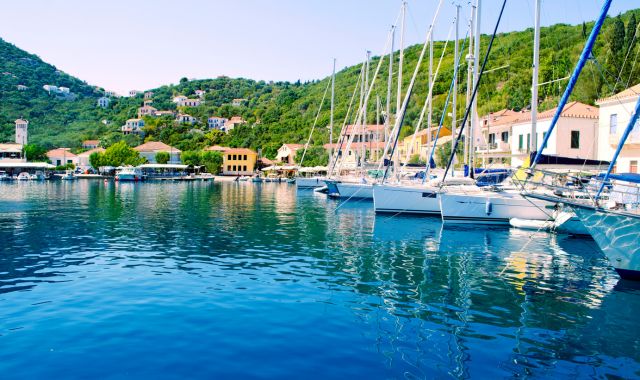 Boats and houses in the Kioni harbor in Ithaca