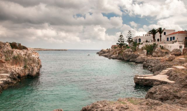 People swimming in the blue water of Avlemonas in Kythira