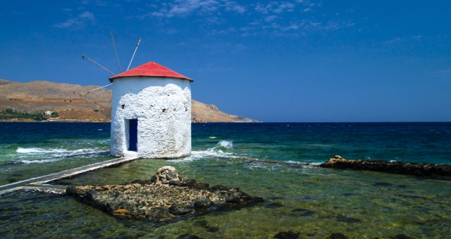 Windmill at the beach of Leros in Greece