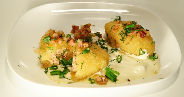 Traditional potato-meat dumplings served with a sour cream-milk sauce