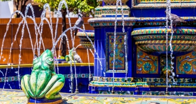 A colorful fountain in Plaza Alta square with ceramics and ornamental frogs in Algeciras, Spain