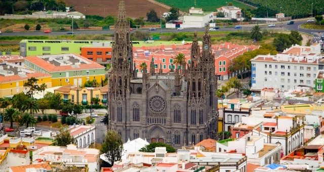 The church of San Juan Bautista surrounded by colorful houses in the town of Arucas in Gran Canaria, Spain