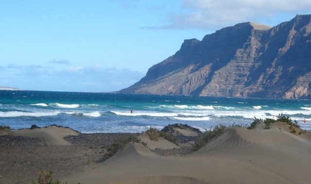 The Famara mountain and a wavy beach in Lanzarote, Spain