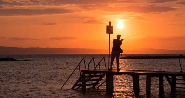 Fishing in the port area of Ayvalık, Turkey, at sunset