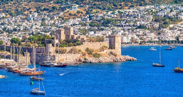 Sailboats docked in front of the Castle of St. Peter in Bodrum 